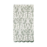 Isolated view of a single green paper napkin showing the green bough print pattern and the dark green scalloped edge.