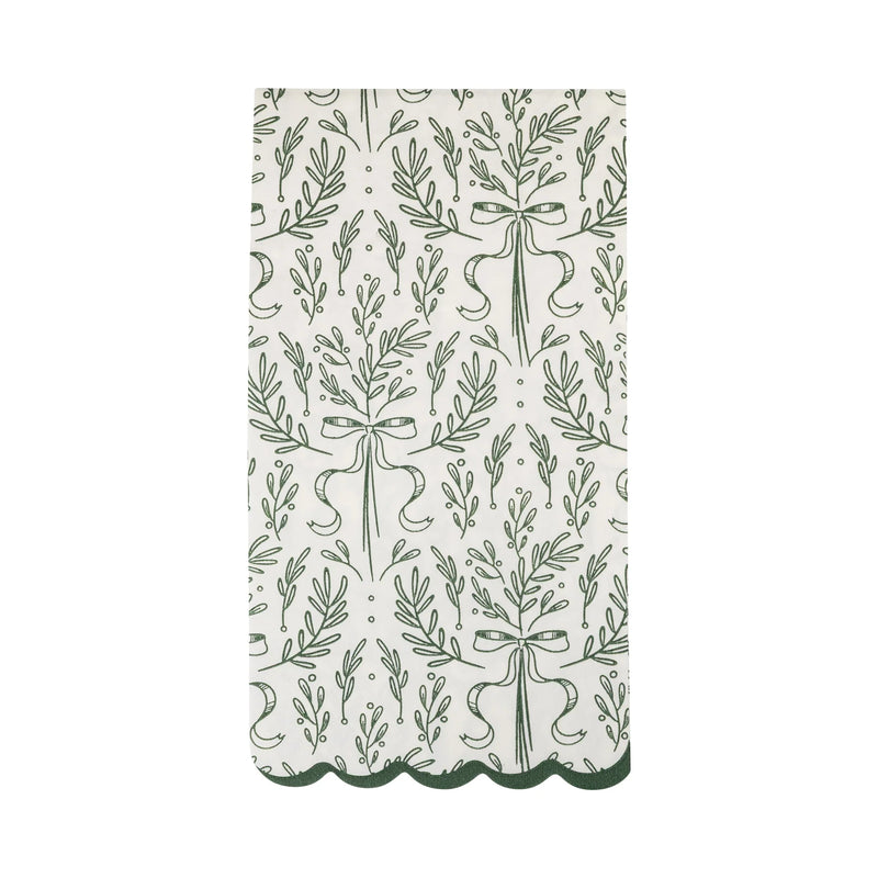 Isolated view of a single green paper napkin showing the green bough print pattern and the dark green scalloped edge.
