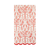 Isolated view of a single red and white napkin showing the continuous red bough illustration and scalloped edge.