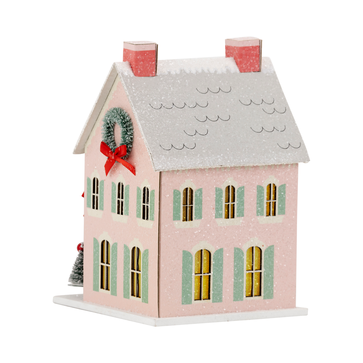 Isolated view of the pink glitter Christmas putz house showing the pale green shutters and snow-dusted roof.