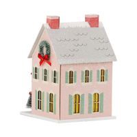 Isolated view of the pink glitter Christmas putz house showing the pale green shutters and snow-dusted roof.