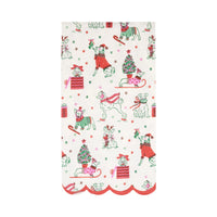 Isolated view of the Christmas dogs pattern holiday dinner napkins with a red scalloped edge border.