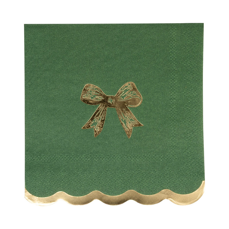 Close-up of a single dark green napkin featuring a gold foil accents bow and a scalloped edge.