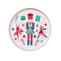 Isolated view of a single nutcracker plate showing the vibrant ballet-inspired illustrations and gold foil rim.