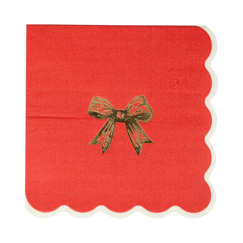Close-up of a single red Christmas napkin featuring a gold foil accents bow design.