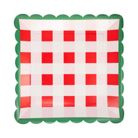 Isolated view of a single red gingham paper plate showing the red and pink plaid pattern and green scalloped edge.