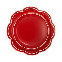 Isolated view of a single red paper plate showing the wide scalloped edge plates and white border lines.