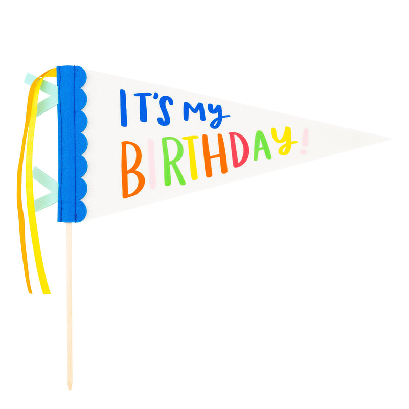 A white Felt pennant banner on a wooden dowel with vibrant lettering and satin ribbons.