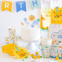 Animal birthday cups arranged on kids party table setup