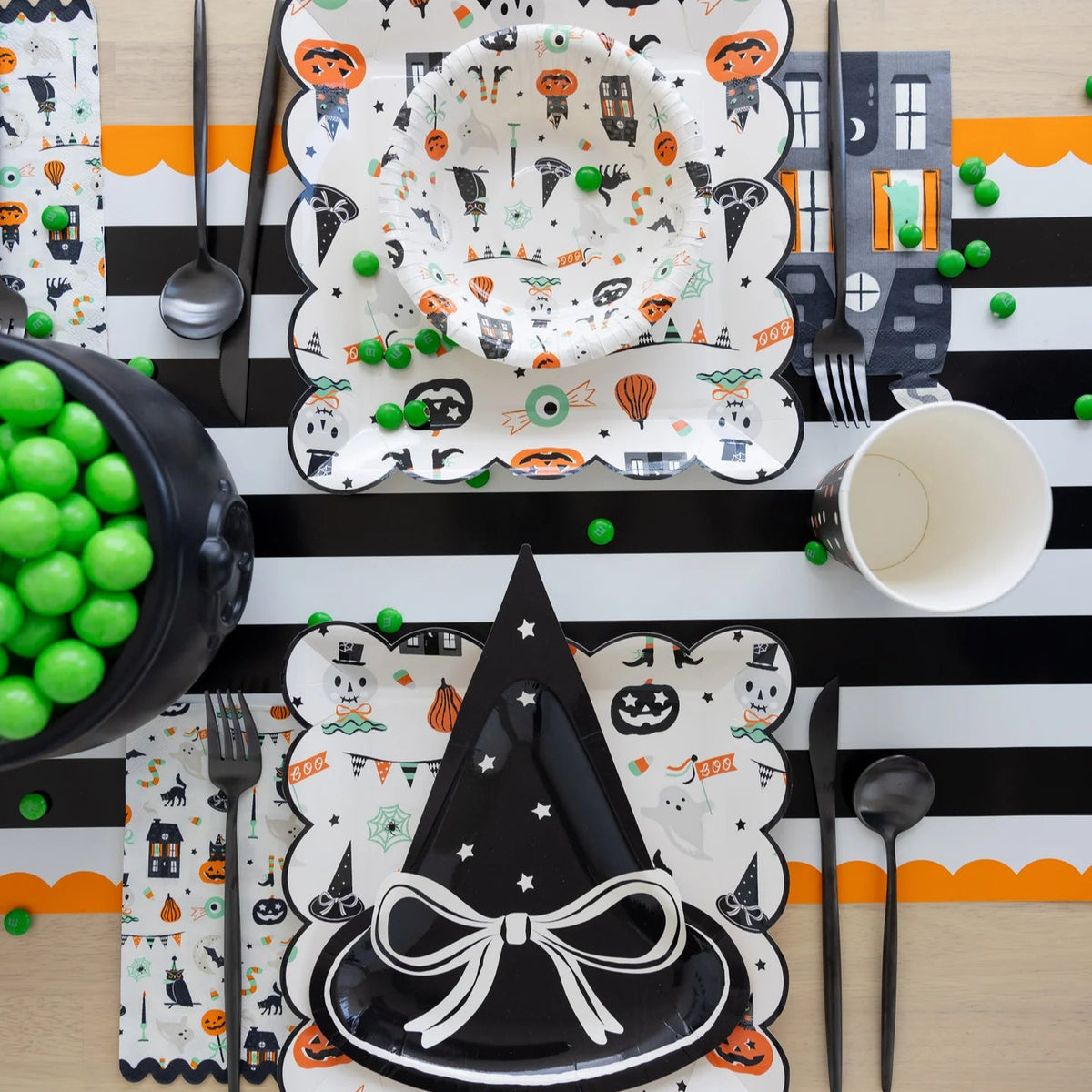 Halloween dinner table set with Tricks & Treats napkin, bowl and witch hat plate