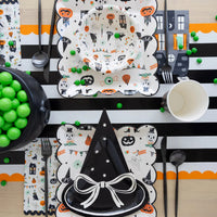 Halloween dinner table set with Tricks & Treats napkin, bowl and witch hat plate