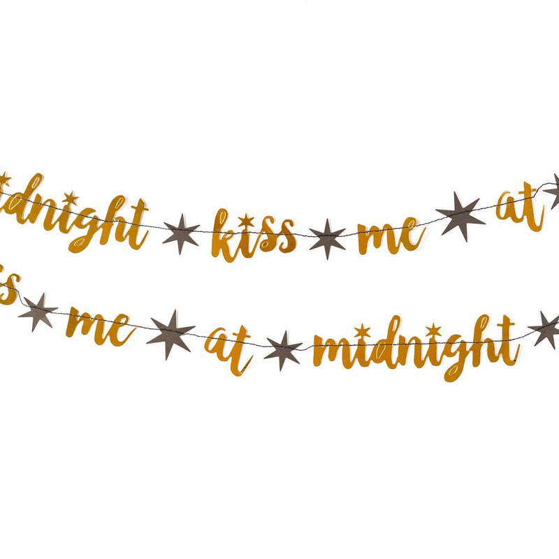 Close-up of gold Kiss Me at Midnight garland letters stitched on string