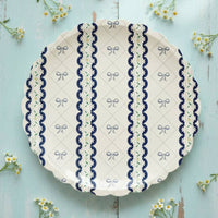 Blue ribbon dinner plate centered on a light blue wood surface with yellow flowers
