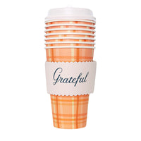 Stack of orange-plaid 16 oz cups with white lid and scalloped “Grateful” wrap.