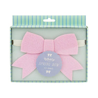 Retail packaging for a pink felt spring bow banner, part of the Easter party decorations collection.