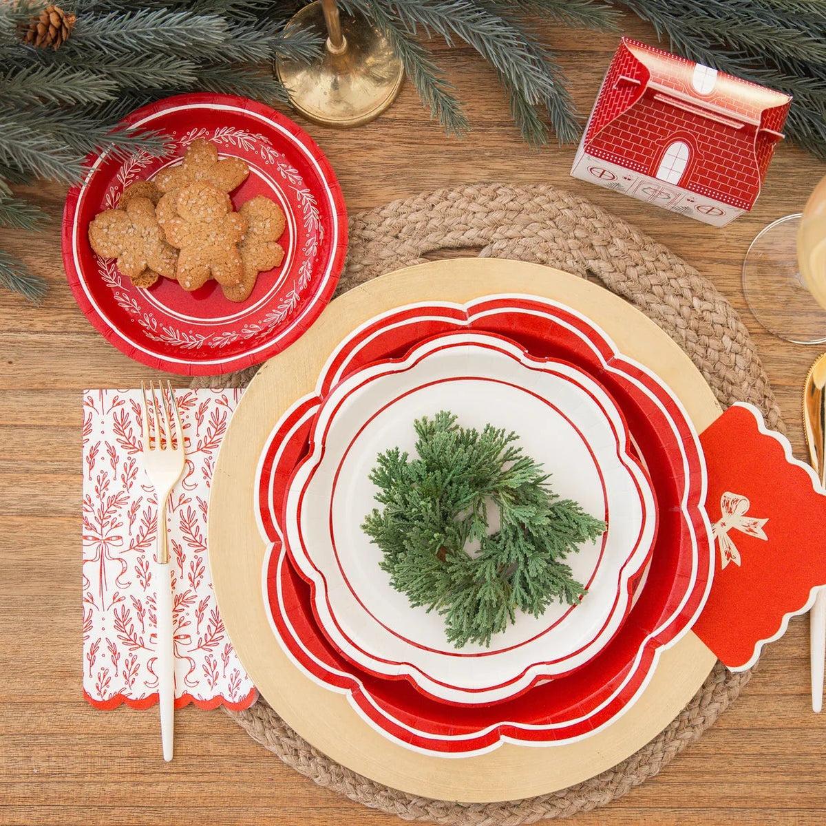 Overhead view of a fully decorated holiday table with gingerbread cookies and a paper dessert plate used as a small plate.