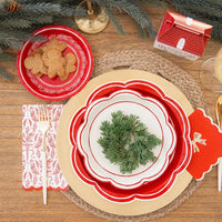 Overhead view of a fully decorated holiday table with gingerbread cookies and a paper dessert plate used as a small plate.