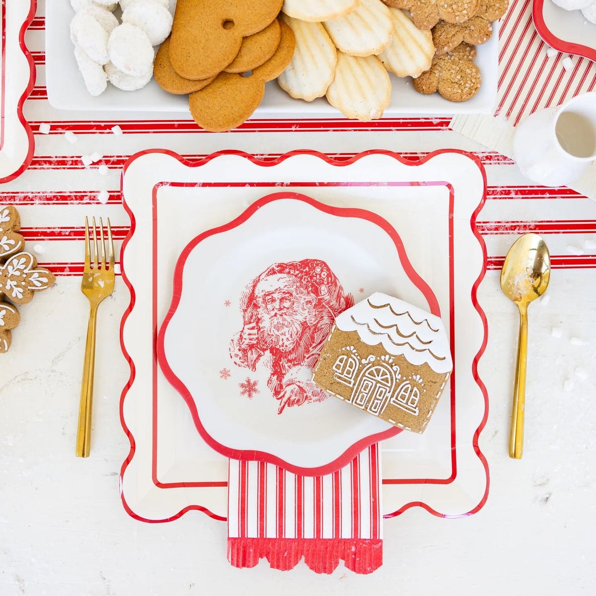 Close-up of a layered place setting with one of the Santa Reindeer Plates and a gingerbread cookie.
