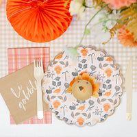 Gingham place setting with floral turkey plate, plaid guest towel, and kraft “Le gobble” cocktail napkin.