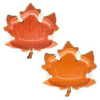 Two orange maple leaf paper plates with gold-foil trim on a white background.