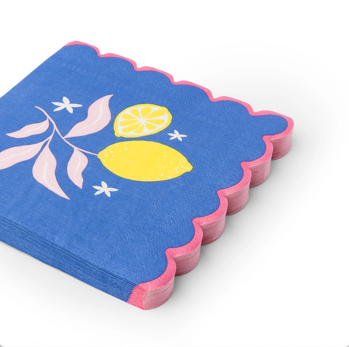 Stack of cobalt napkins with yellow lemon illustration and pink scalloped edges, shot at an angle.