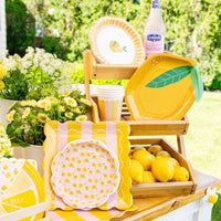 Summer party setup with striped square plates and lemons