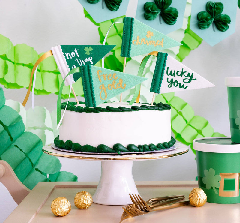 Leprechaun trap pennants displayed on cake with green decor