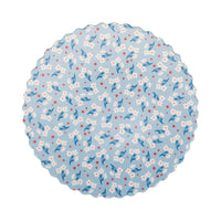 Flat lay of light blue floral bamboo plate with white blossoms and red stars on white background