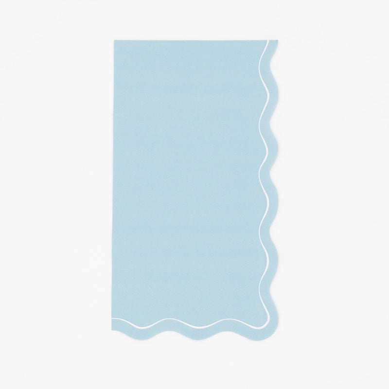 Solid light blue guest towel with a soft wavy scalloped white-outlined edge, flat view on white background.