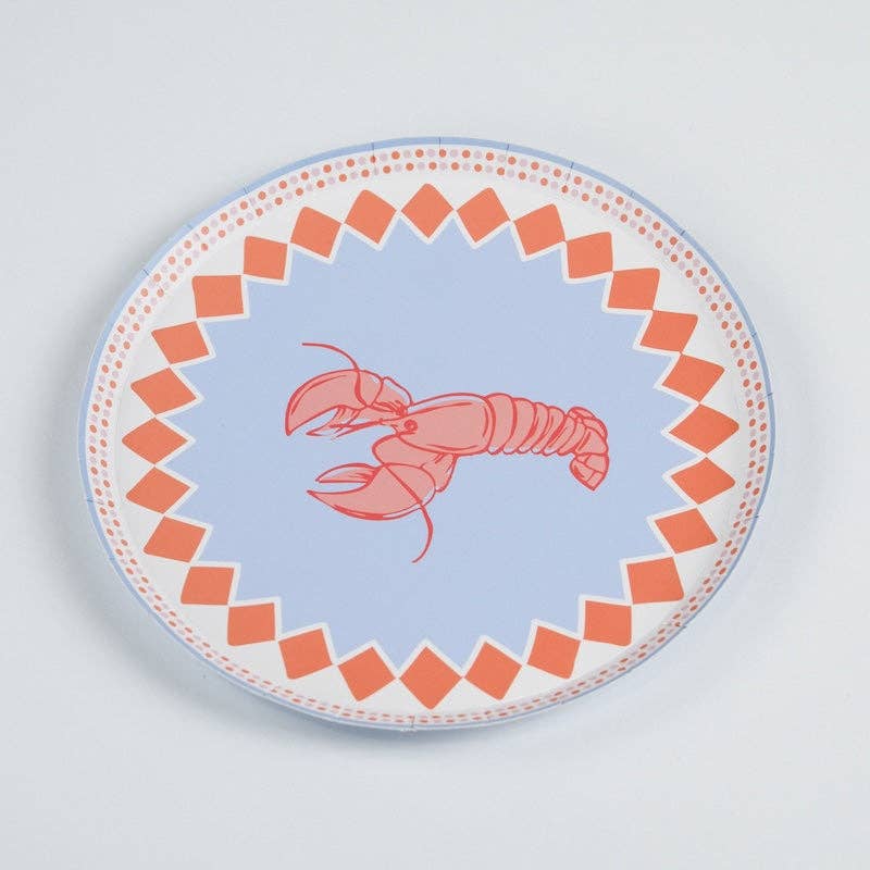 Single lobster print paper salad plate on a white surface, photographed slightly above straight-on. Full plate visible: periwinkle blue center ground with a red-and-pink line-drawn lobster facing left, claws extended. Orange diamond-check border around the full circumference with a pink dotted outer ring. Blue tinted edge visible at plate rim.