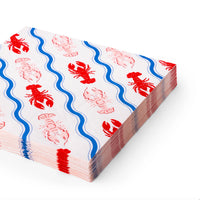 Angled stack of guest‑size napkins showing repeating red lobsters and blue wavy stripes.