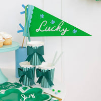 Lucky felt pennant styled on a St. Patrick’s Day dessert table with green party decorations