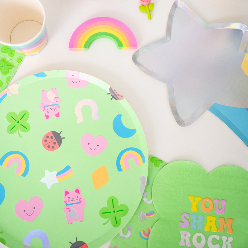 Lucky Me large plate styled with rainbow party decor and green shamrock napkins