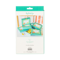 Back of lunchbox shaped treat box packaging showing styled product scene with teal boxes stacked and filled with yellow candies on white desk