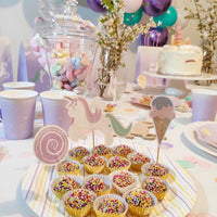 Dessert plate with colorful sprinkle truffles and unicorn themed toppers