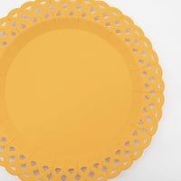Angled overhead of the marigold yellow basketweave plate showing the lattice cutout border and embossed detail.