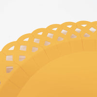 Extreme close-up of a marigold yellow basketweave paper plate showing the raised rim and the intricate woven lattice cutout border in bright golden yellow.