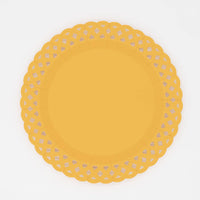 Bright marigold yellow basketweave dinner plate with an embossed woven texture and a scalloped lattice cutout border, overhead view on white background.