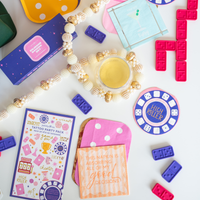 Cocktail party setup with martini napkin, dominoes, and party accessories