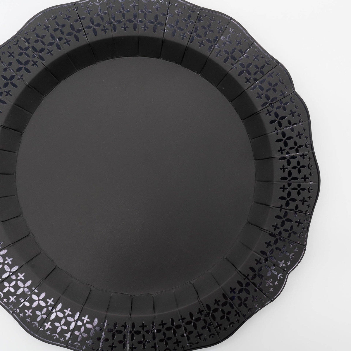 Front facing flat view of the black die-cut scalloped paper dinner plate showcasing its deep matte finish and lace edges.