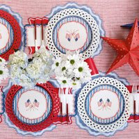 Overhead view of a complete Americana Party Supplies table with flags, stars, and flowers.