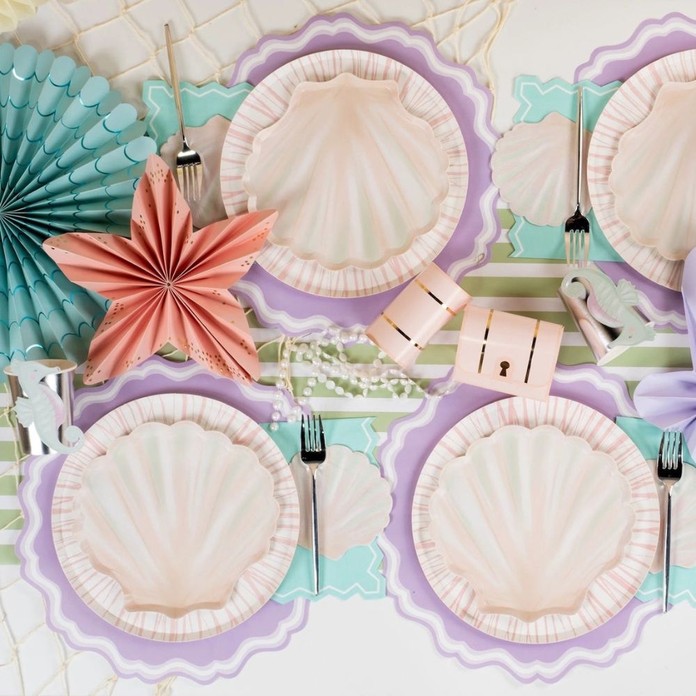 mermaid party plates with shell shaped dessert plate and pastel decor.