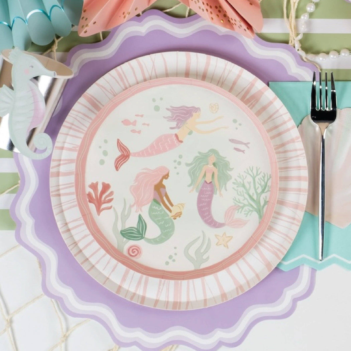 mermaid plate layered on lavender scallop placemat with pastel party setup