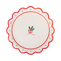 Cream Merry Christmas dessert plate with a red and green "Merry Christmas" design, a holly sprig, and a wavy red scalloped edge.