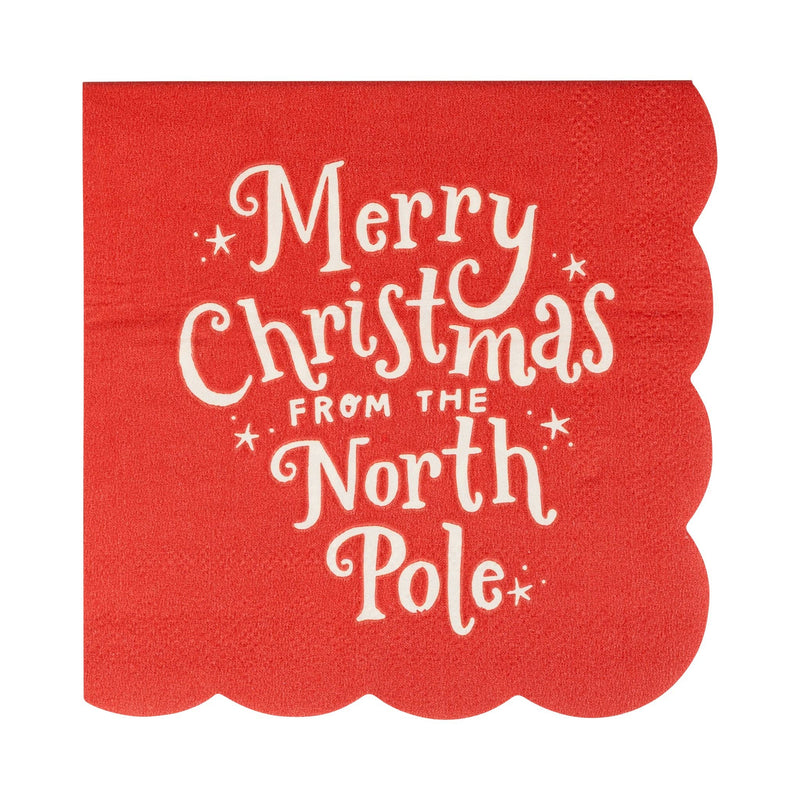 Red cocktail napkin with “Merry Christmas from the North Pole” text and scalloped edges