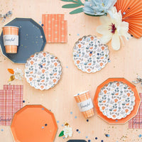 Fall table styling: Navy premium plates styled with floral dessert plates, orange plates, confetti, and plaid cups.