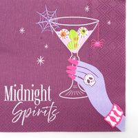 Close-up of the plum Midnight Spirits Halloween cocktail napkin with an eyeball martini, spiderweb, pink spider, and white script text