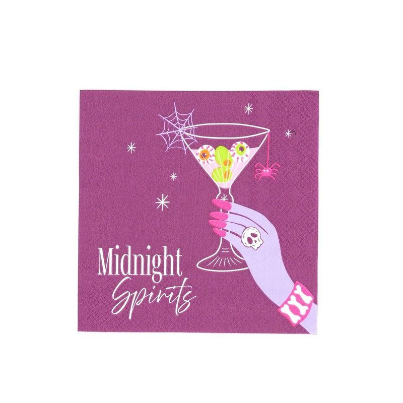 Midnight Spirits Halloween cocktail napkin in plum purple showing a hand with a skull ring raising a martini with green eyeball olives, a spiderweb, a pink spider, and white stars, with white script text