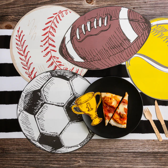 Baseball and tennis ball placemats on a black and white stripe runner with a plate of pizza.