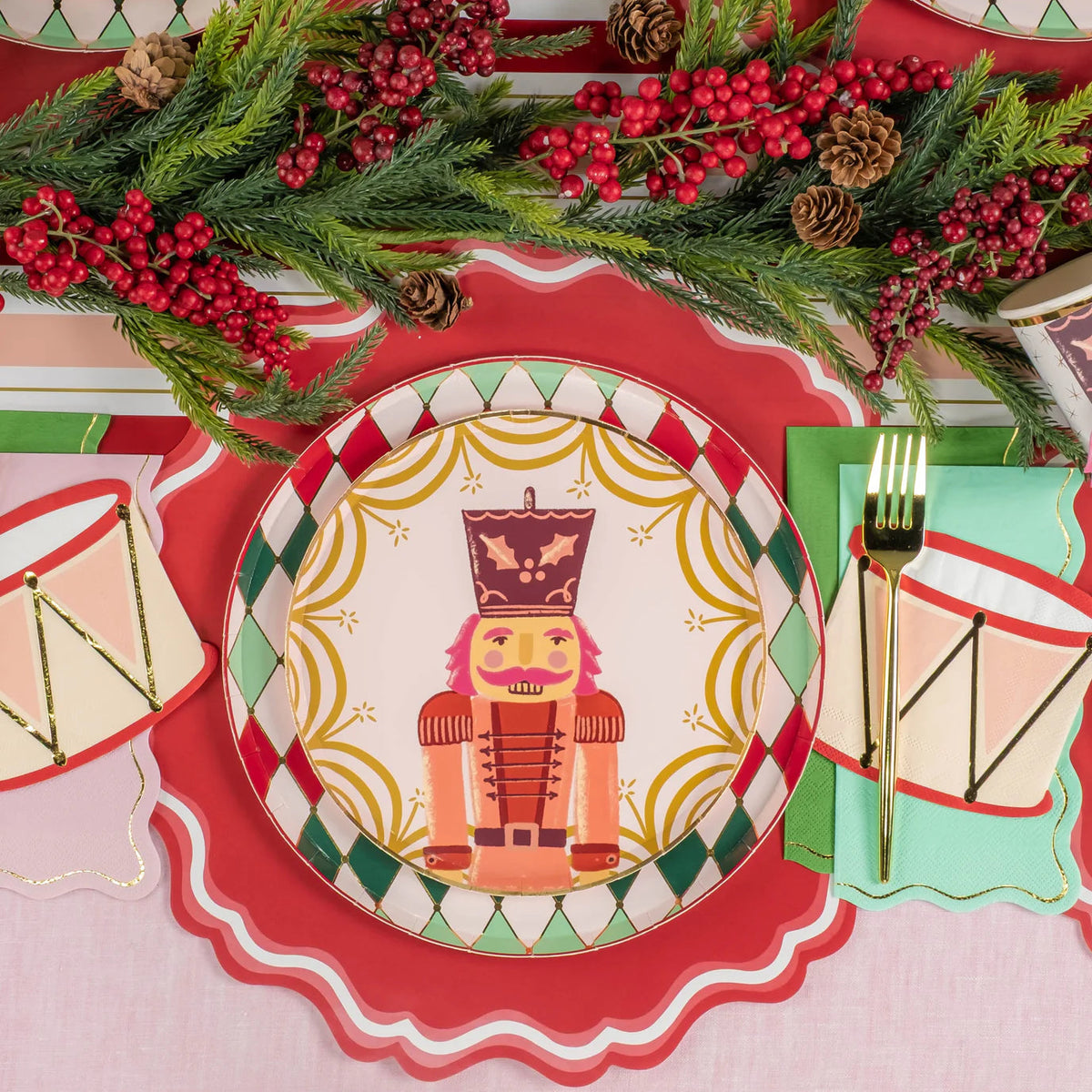 Place setting with nutcracker plate and icy blue guest towel with gold edge.